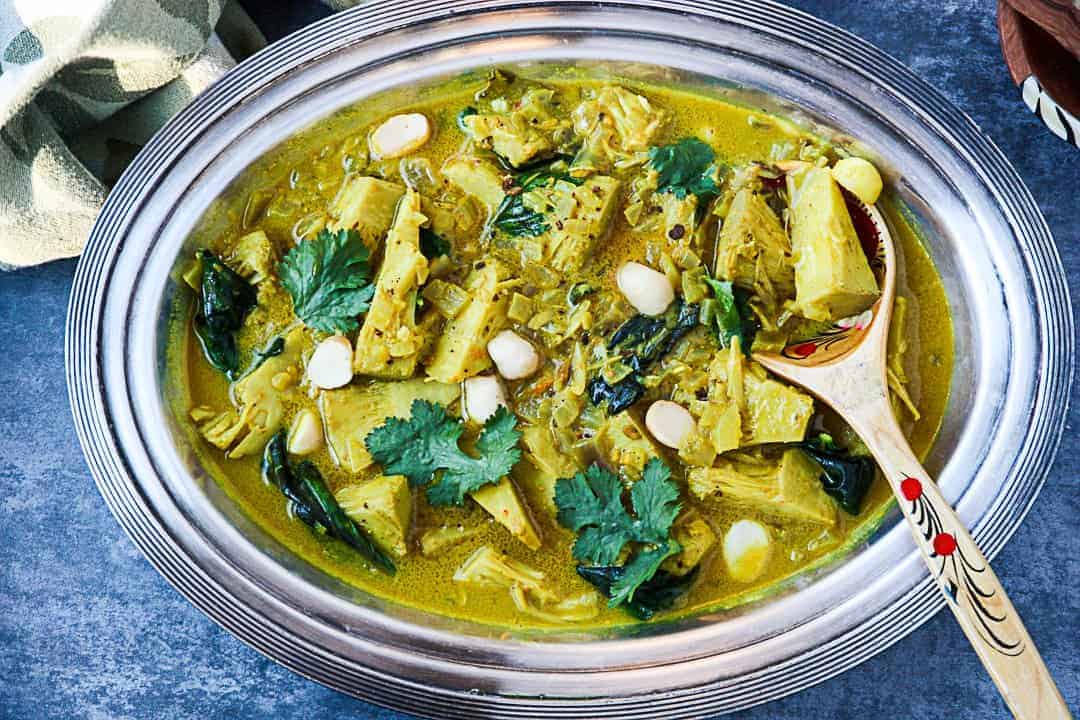A bowl of food on a plate, with Jackfruit