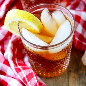 A glass on a table, with Iced tea