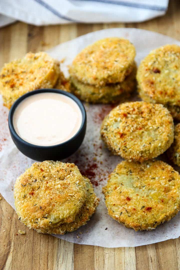 Oven Fried Green Tomatoes on parchment paper on a table