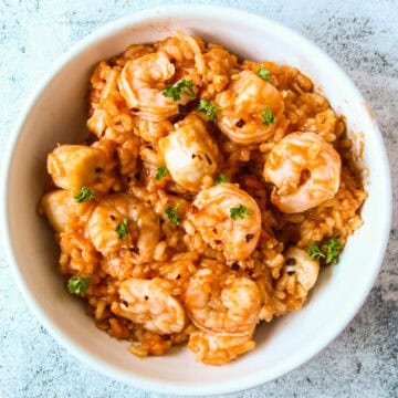 Risotto marinara in a white bowl.